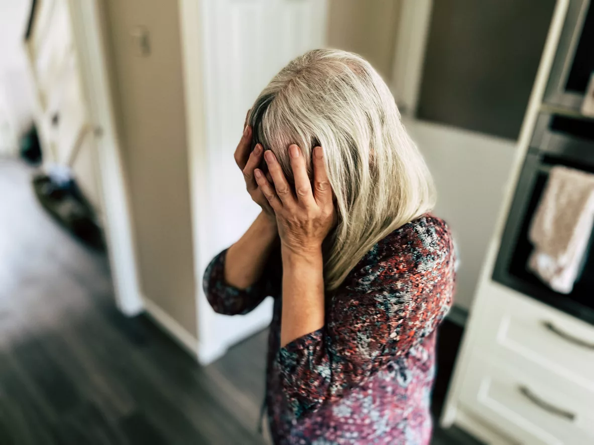 Depressed woman with head in hands